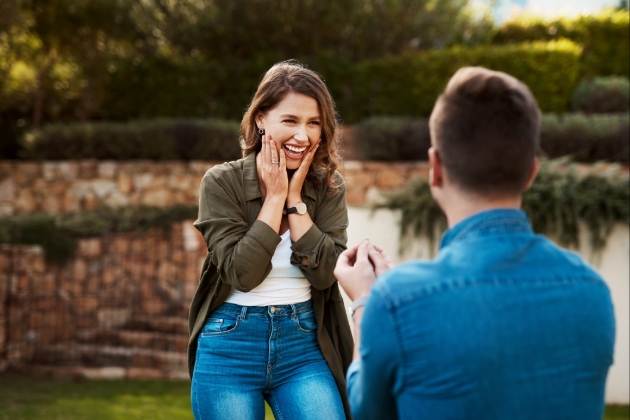 Man in denim shirt proposes to woman