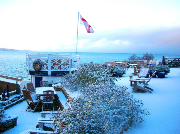 Terrace at Cary Arms & spa in the snow with sea view
