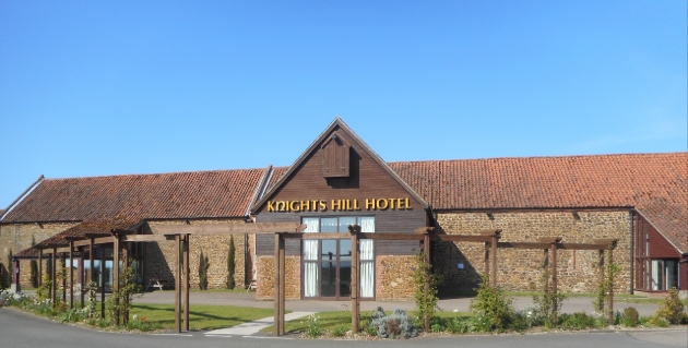 Knights Hill Hotel & Spa, brown brick building front of hotel with wooden walkway