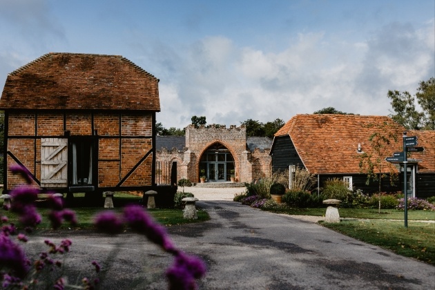 brick church looking building with two barn in front of view