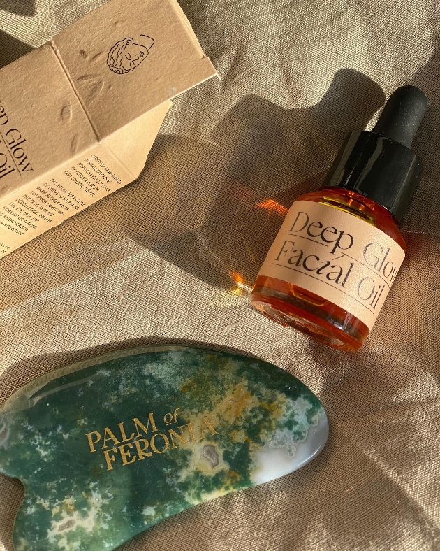 blue palm stone and bottle of oil