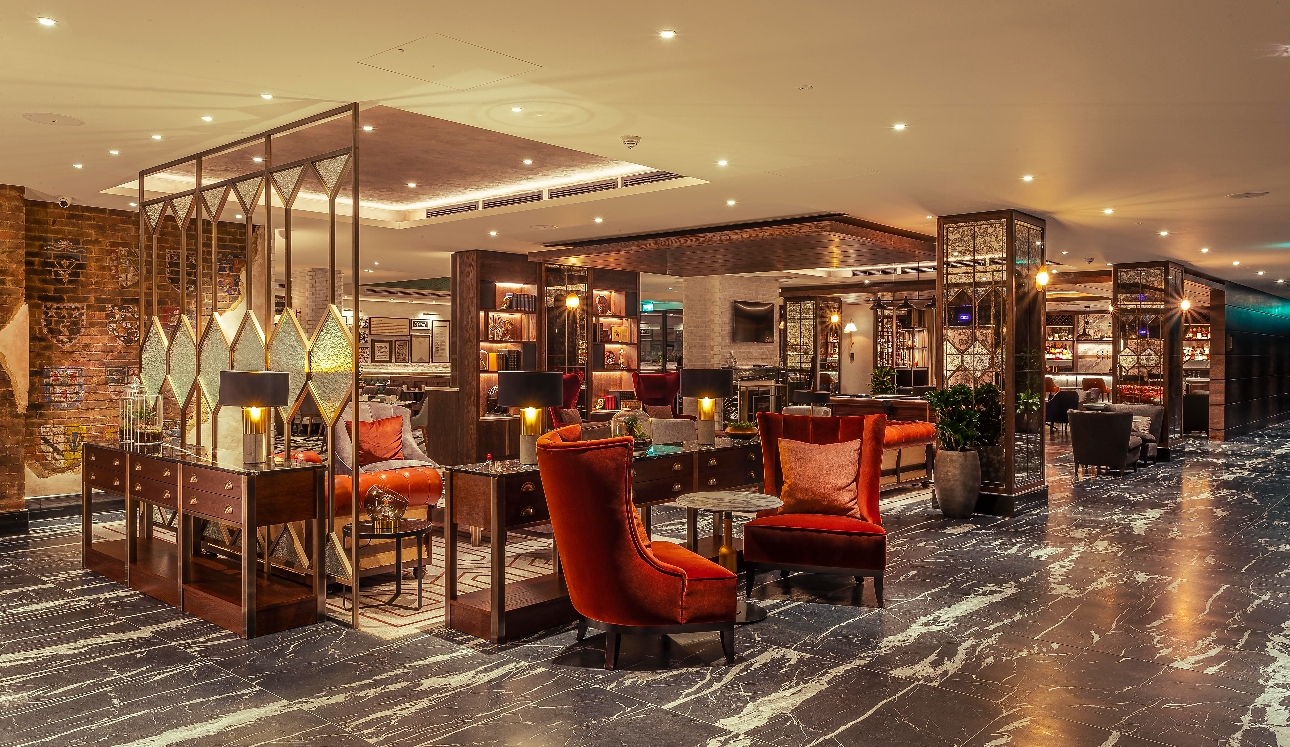 interior of new hotel bar, brick walls velvet chairs low lighting