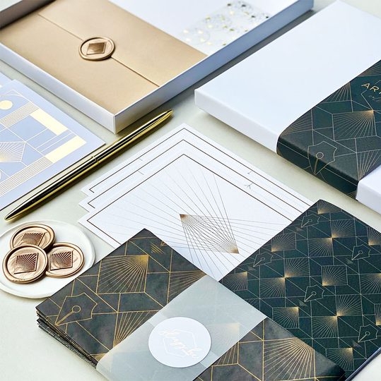 stationery suite in navy and gold and an art deco print