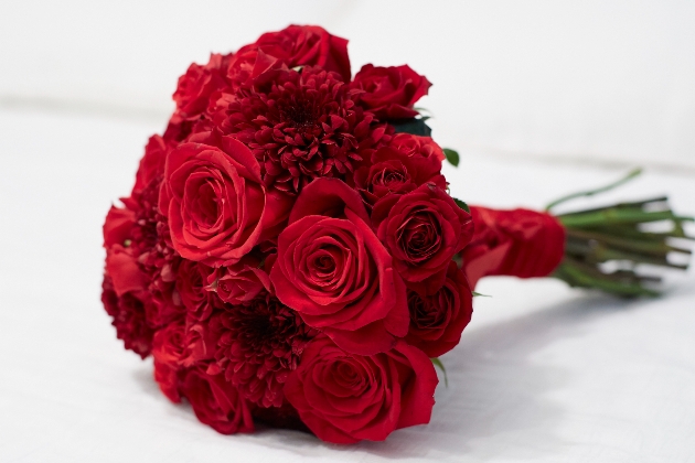 a red rose bouquet laying on a table