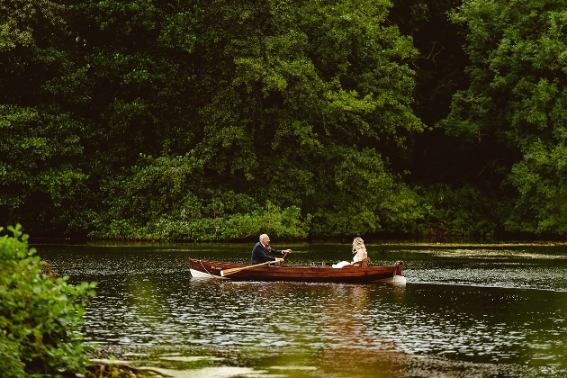 couple in a wooden boat on a lake