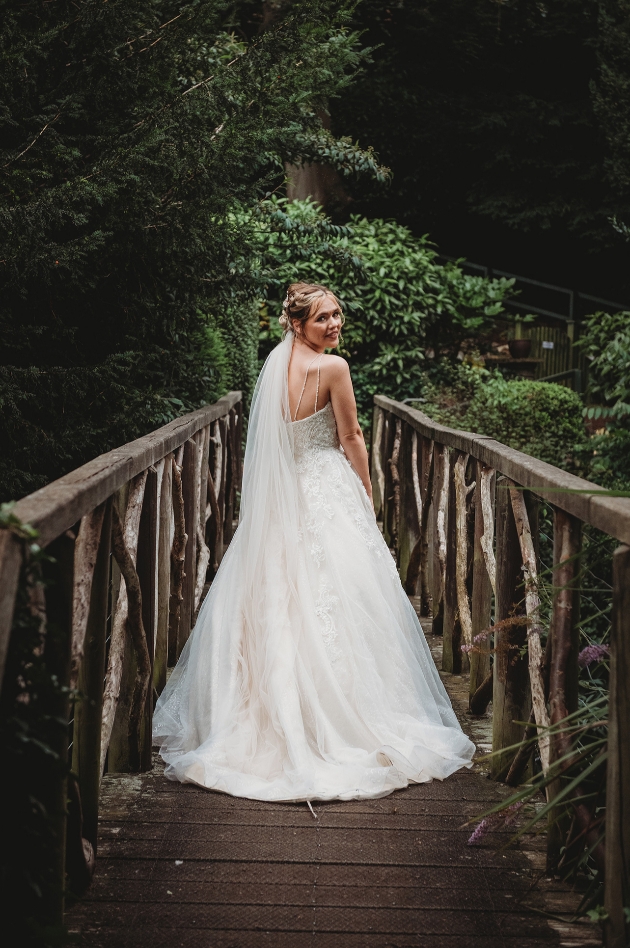 Bride standing on bridge