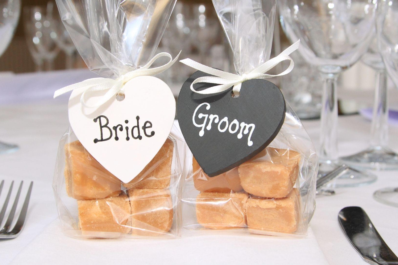 two bags of fudge with wooden plaques saying bride and groom