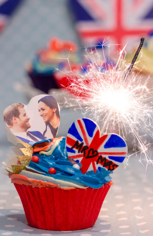 red white and blue cupcake with a sparkler, crown and a picture of Harry and Meghan