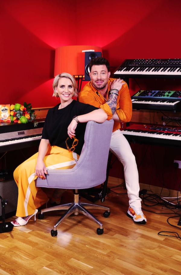 Duncan James from Blue and Claire Richards from Steps sat on chair near keyboards