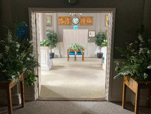 entrance to ceremony room with floral pedestals