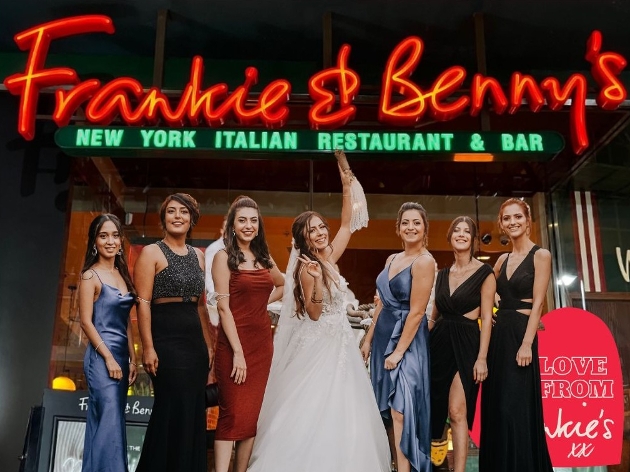 bride and friends in front of frankie and benny's restuarant