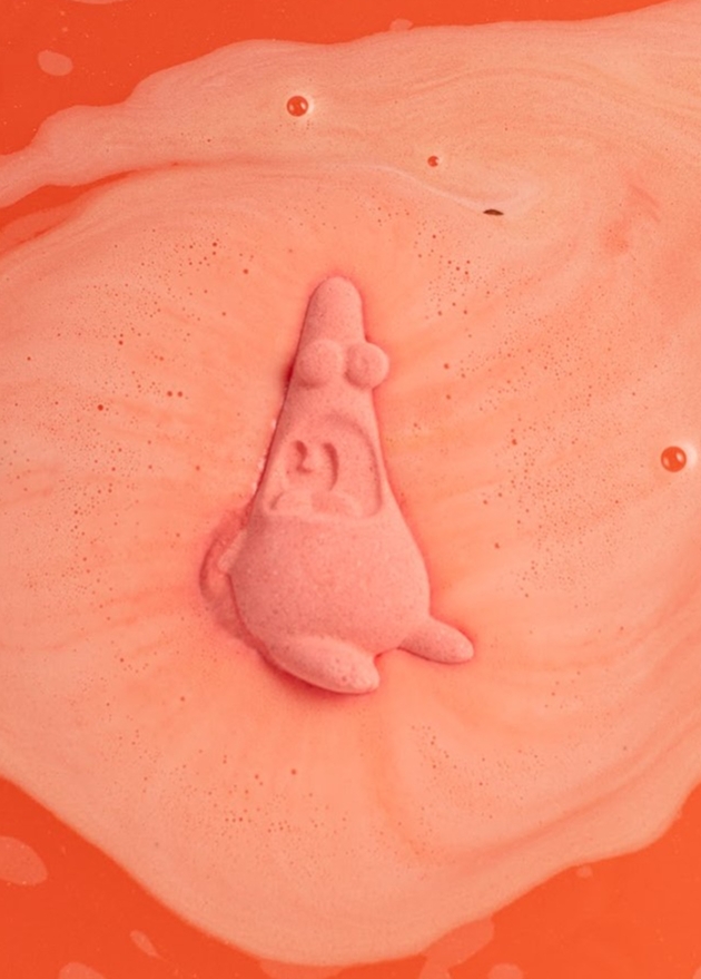 Pink bath bomb in water. 