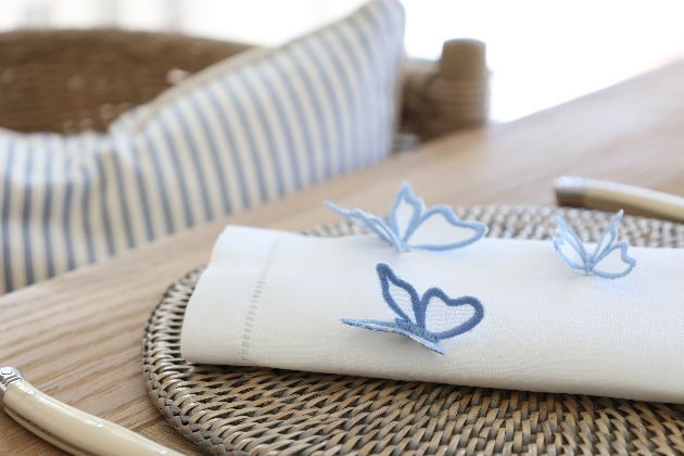 A white napkin with butterflies sewed on