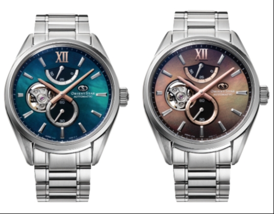 Two silver watches, one with a blue face and bronze detailing and teh other with an orange face