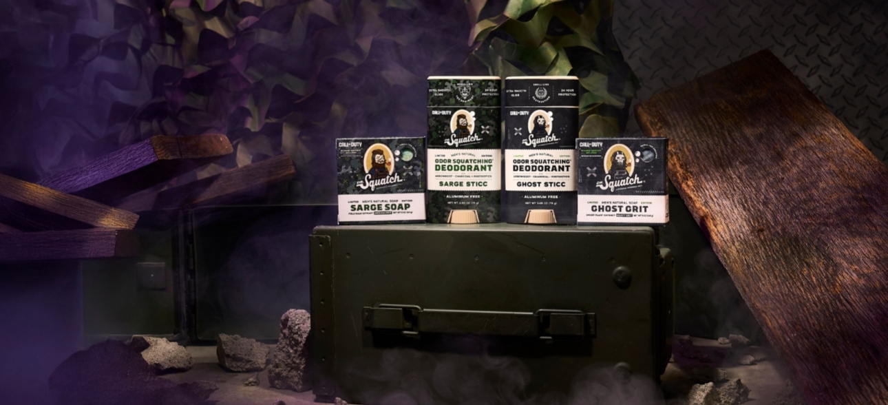 a collection of deodorants and soaps on military equipment with dark background