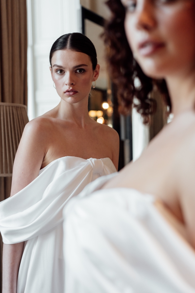 two women posing in slouchy wedding dresses