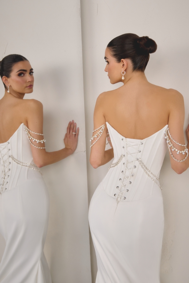 woman in wedding dress posing in mirror