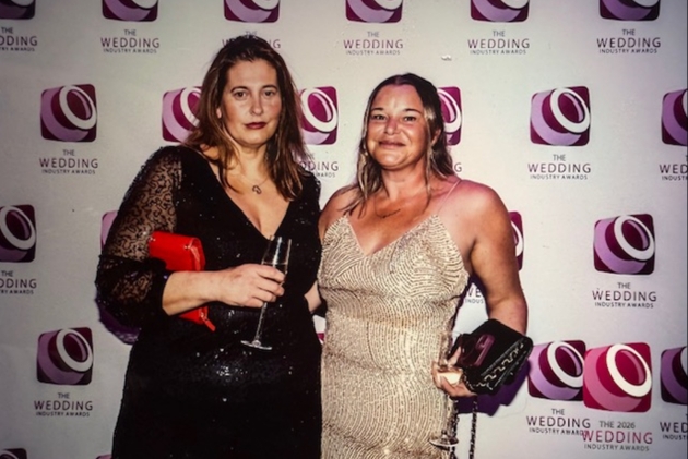 Two women posing wearing evening wear