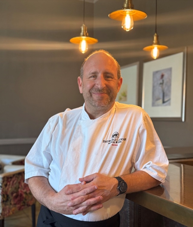 Robert Newall smiling at the camera wearing his chef uniform