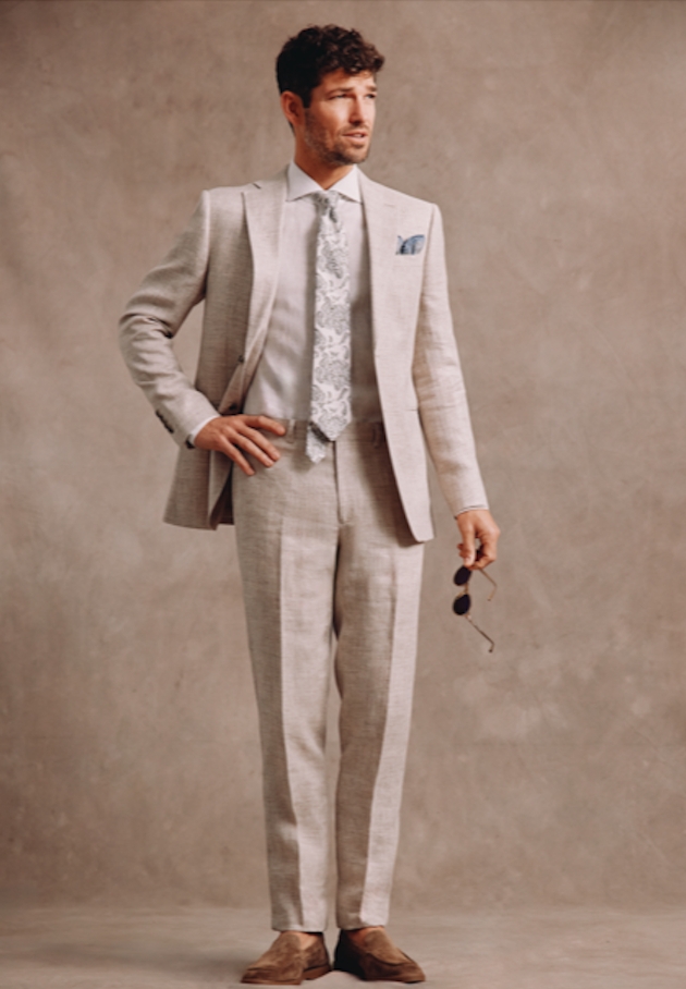 A man in a cream suit