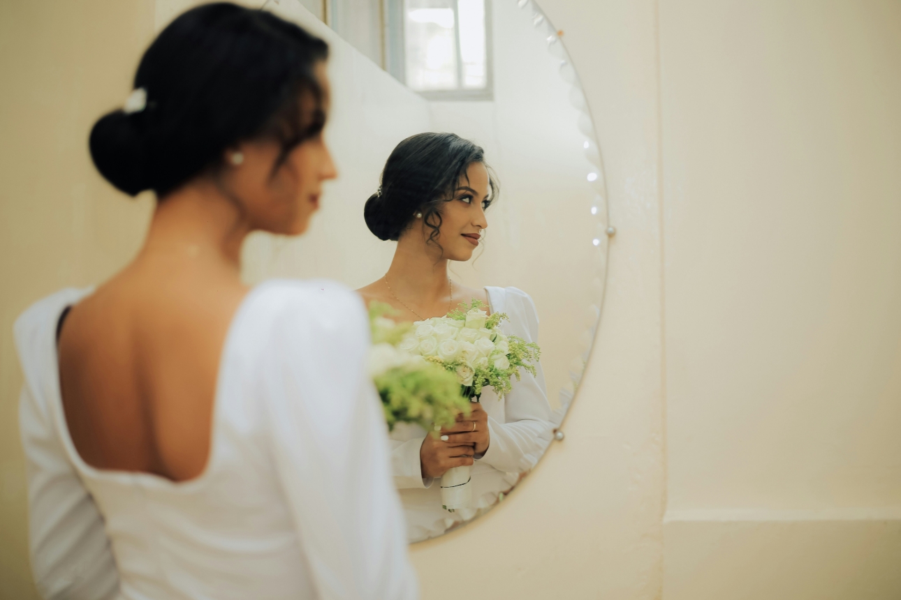 bridal portrait of bride looking in mirror